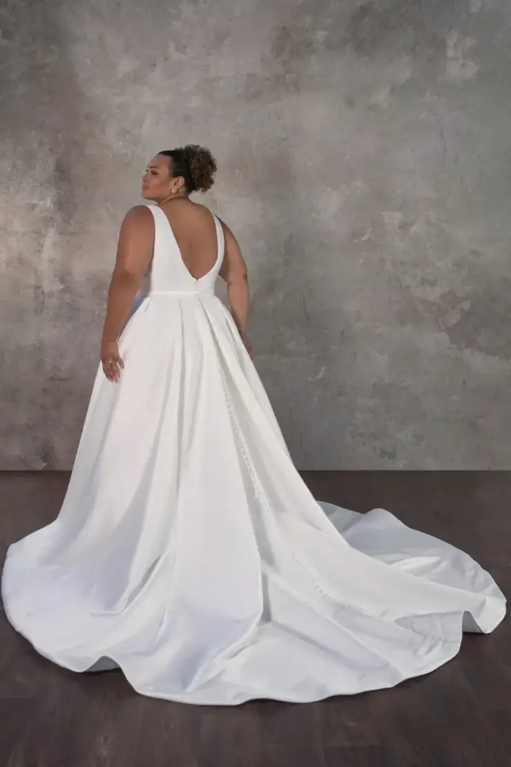 model is wearing a sleeveless a-line wedding dress