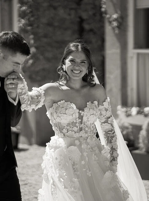 Сouple wearing a white gown and a black suit, vlack and white photo