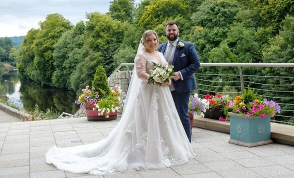 Сouple wearing a white gown and a blue suit