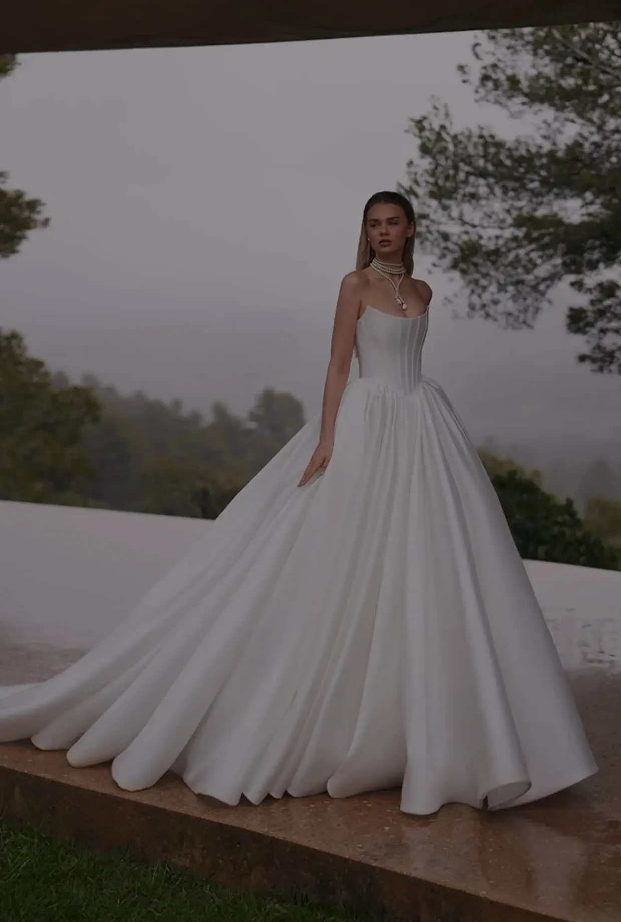 Model wearing a white dress. Mobile image