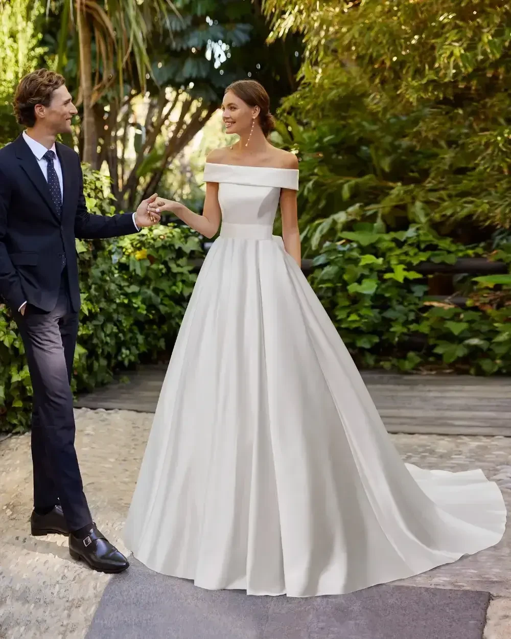 Сouple wearing a white gown and a black suit